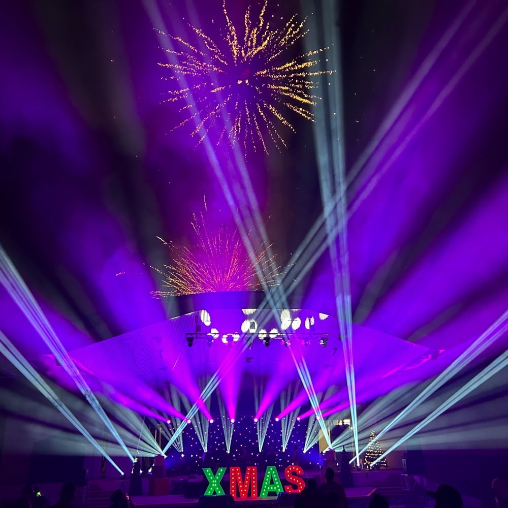 A large outdoor stage that is decorated for Christmas with a large Christmas tree and lighting. Fireworks can been seen above the stage. Live event audio Brisbane, Gold Coast, Sunshine Coast