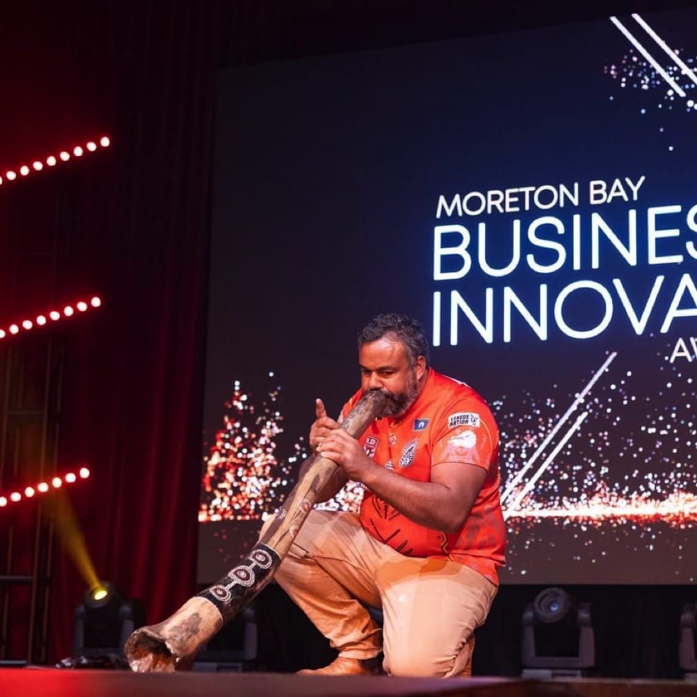 Man plays didgeridoo on stage. Live event audio Brisbane, Gold Coast, Sunshine Coast