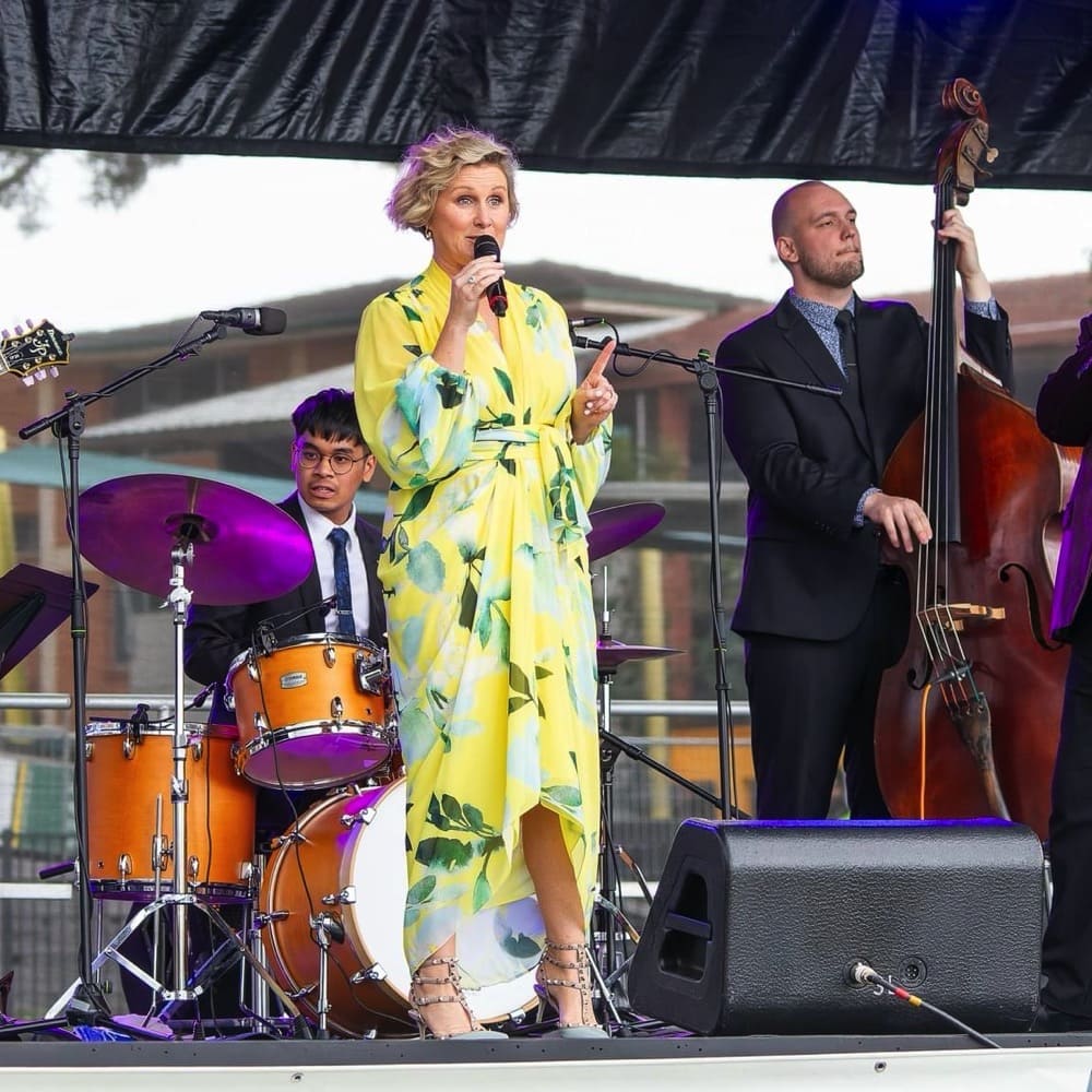 Lady in yellow dress sings with band. Live event audio Brisbane, Gold Coast, Sunshine Coast