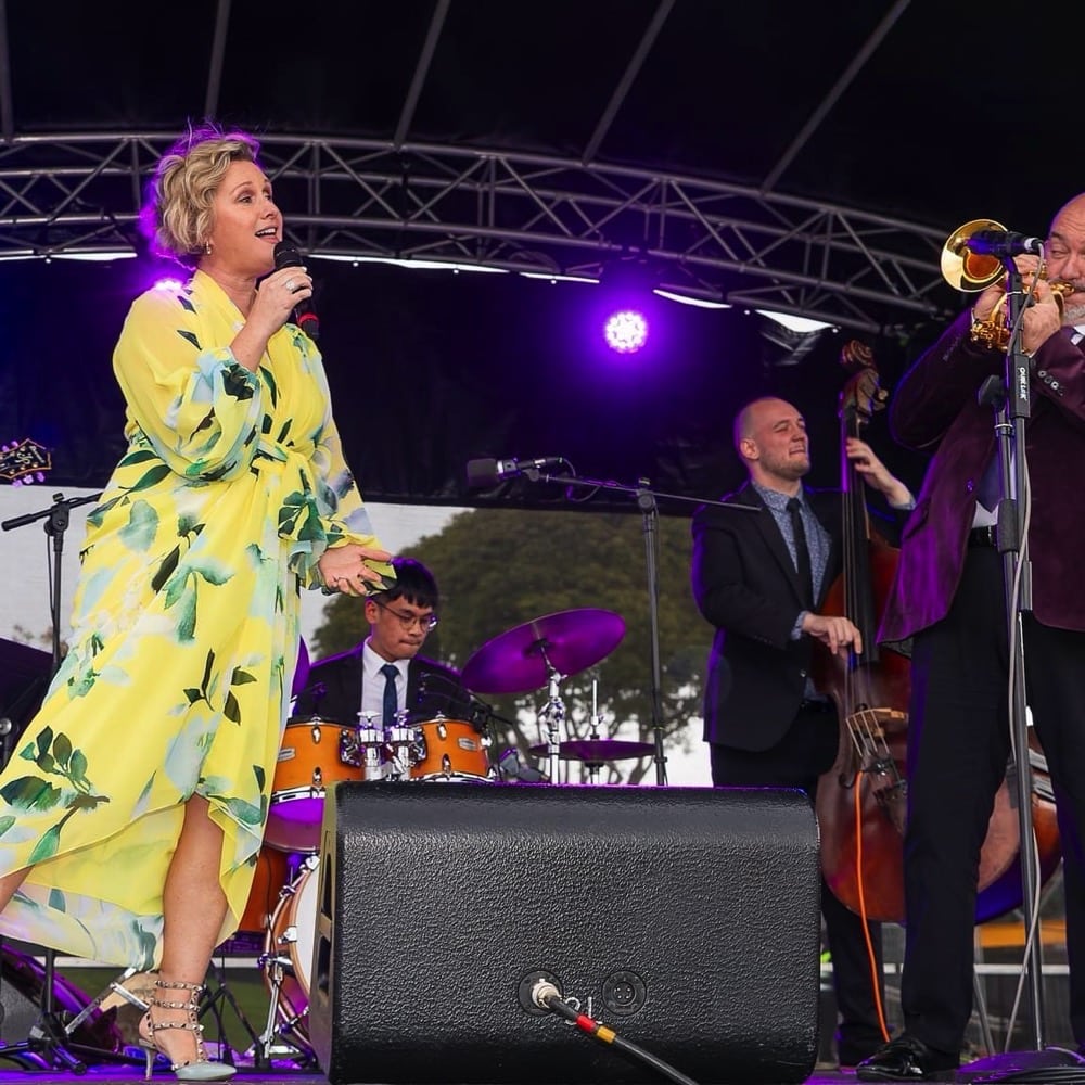 Lady in yellow dress sings as trumpeter plays with a double bass in the background. Live event audio Brisbane, Gold Coast, Sunshine Coast